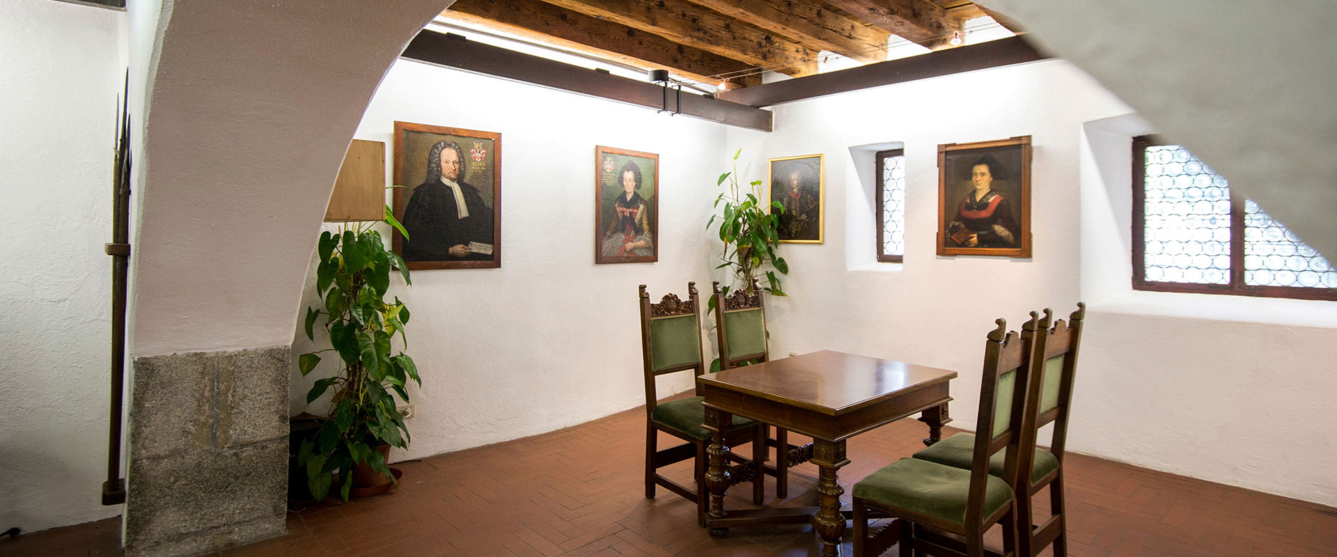 Castello Principesco Sala con antico tavolo in legno e ritratti di nobili principi e duchi.