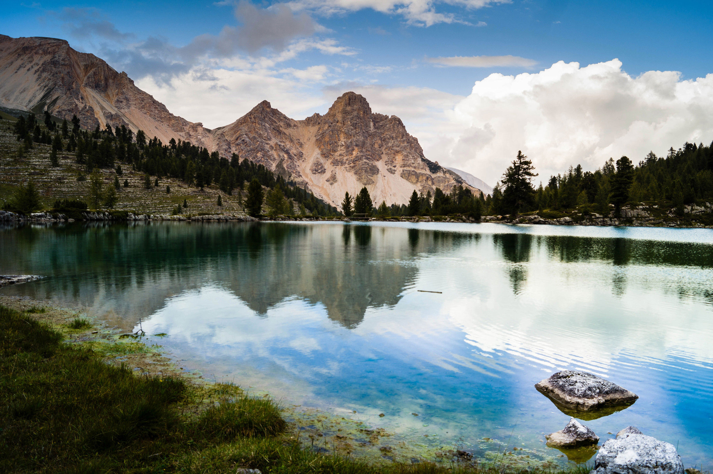 Limpido lago di montagna con riflessi e cime dolomitiche