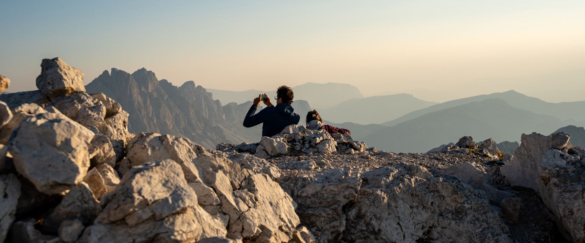 Panorama delle Dolomiti Escursionisti sulla cima di una montagna mentre fotografano il panorama