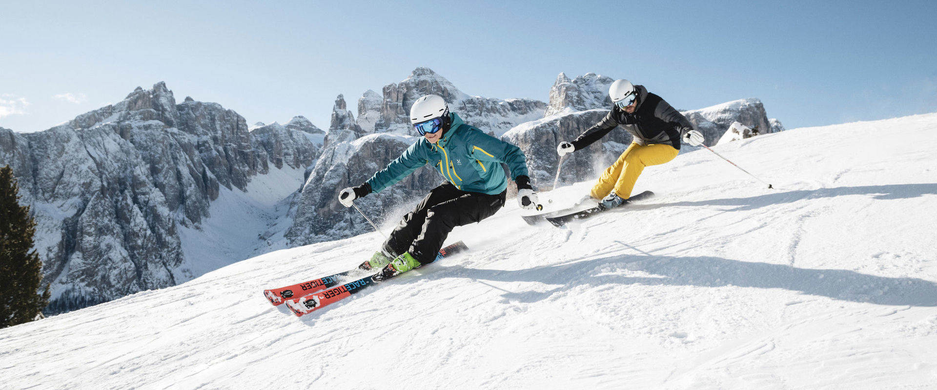 Sciatore sulla pista da sci 2 sciatori scendono lungo la pista appena battuta.