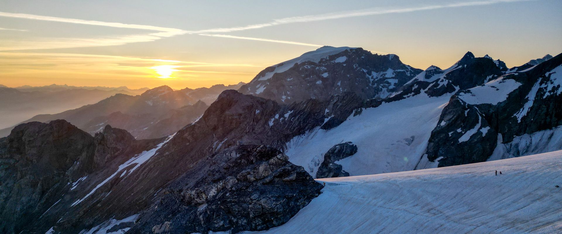 L'alba sulle cime rocciose innevate di un giacciaio